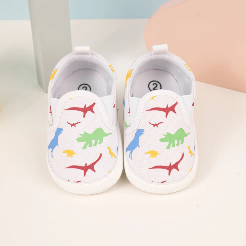 Bottillons slip-on bébé blancs avec motifs de dinosaures colorés pour enfants